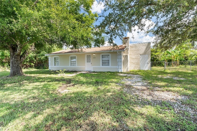 ranch-style home featuring a front yard