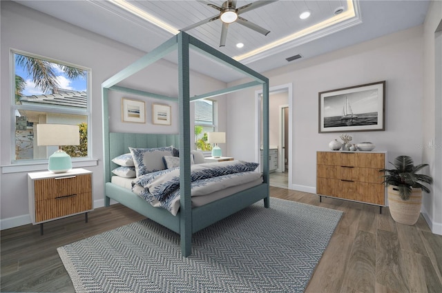 bedroom featuring ceiling fan, a raised ceiling, radiator heating unit, and dark hardwood / wood-style floors