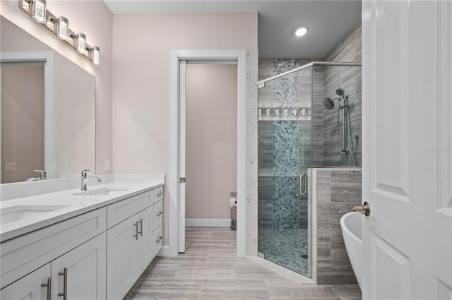 bathroom featuring vanity and plus walk in shower