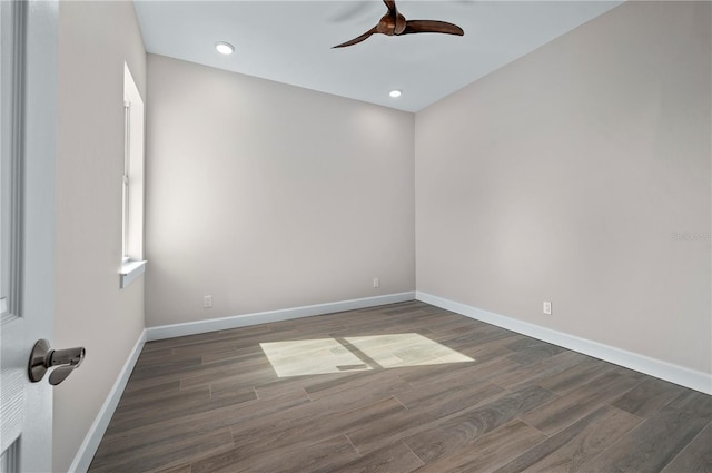 empty room with ceiling fan and dark hardwood / wood-style flooring