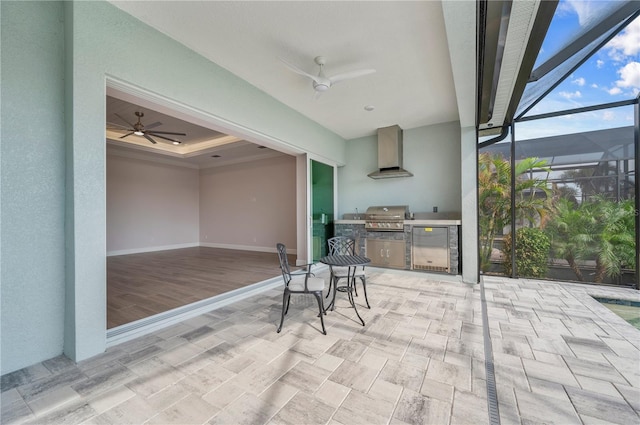 view of patio with exterior kitchen, a lanai, a grill, and ceiling fan