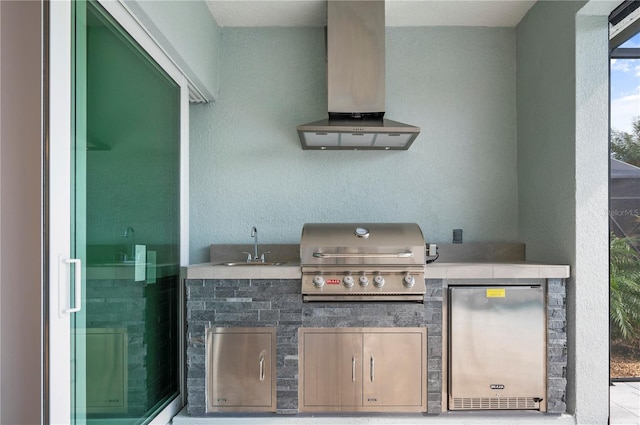 view of patio with an outdoor kitchen, sink, and a grill