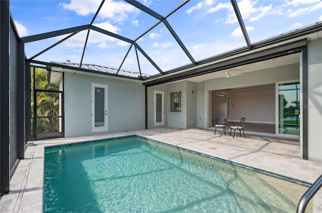 view of swimming pool with a patio and a lanai