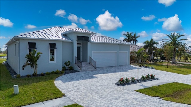 view of front of house with a front yard and a garage