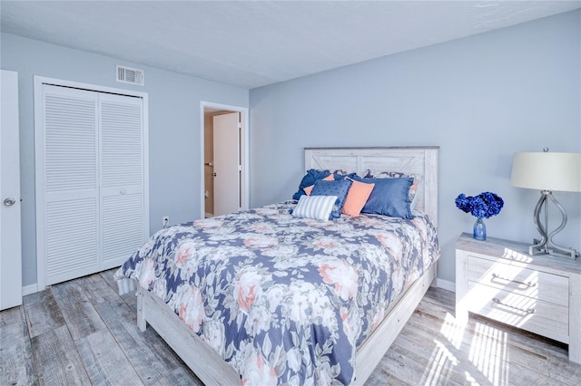 bedroom with a closet and wood-type flooring