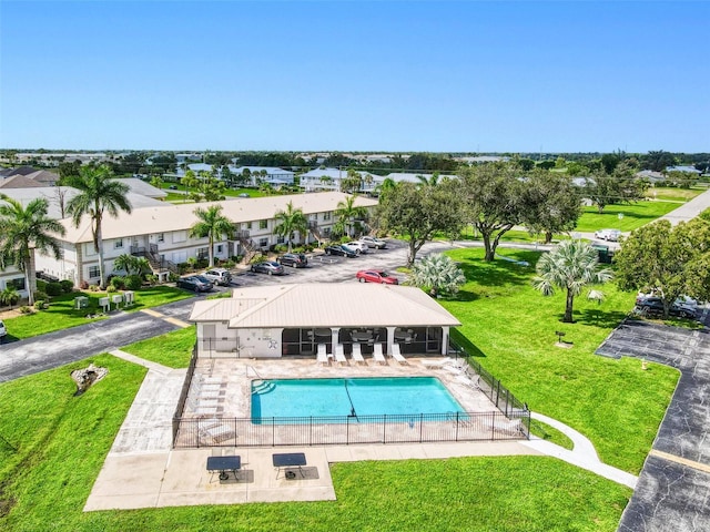 view of swimming pool featuring a patio and a yard