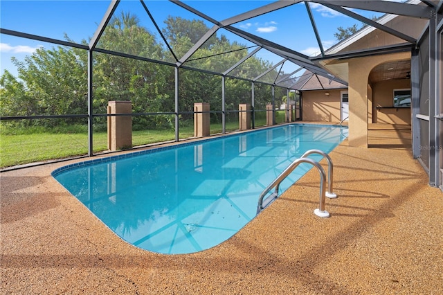 view of swimming pool with glass enclosure and a patio area