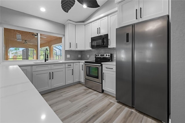 kitchen with sink, white cabinets, and appliances with stainless steel finishes