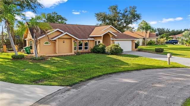 ranch-style home featuring a garage and a front lawn