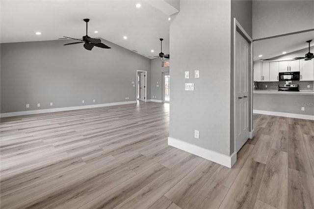 unfurnished living room featuring ceiling fan, high vaulted ceiling, and light wood-type flooring