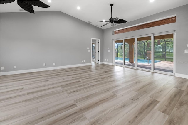 unfurnished room featuring ceiling fan, french doors, light hardwood / wood-style floors, and vaulted ceiling