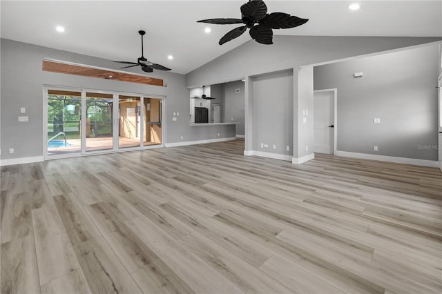 unfurnished living room featuring ceiling fan, high vaulted ceiling, and light wood-type flooring