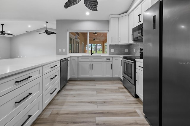 kitchen with decorative backsplash, sink, white cabinetry, and stainless steel appliances