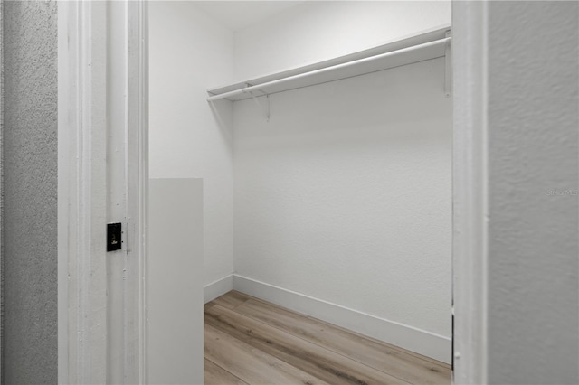 walk in closet featuring light hardwood / wood-style flooring