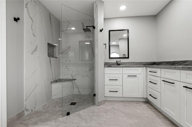 bathroom featuring vanity and tiled shower