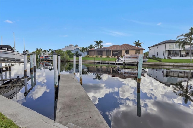 view of dock with a water view and glass enclosure