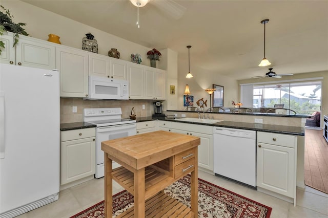 kitchen featuring decorative light fixtures, white appliances, kitchen peninsula, and white cabinets