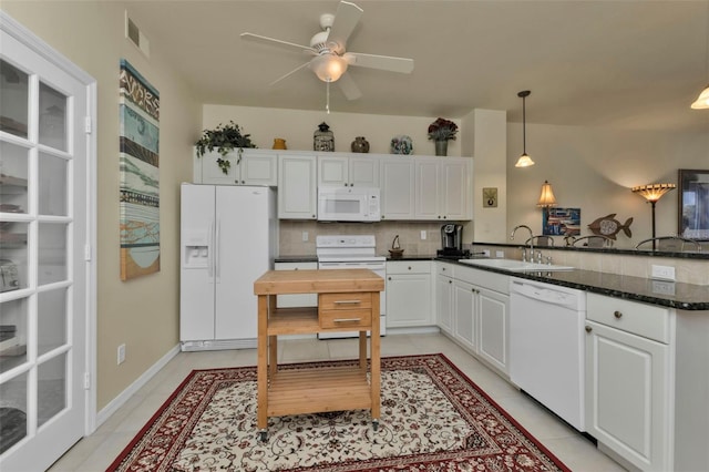 kitchen with white cabinetry, white appliances, kitchen peninsula, light tile patterned floors, and decorative light fixtures