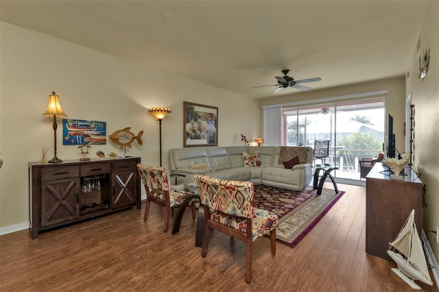 living room featuring ceiling fan and hardwood / wood-style flooring