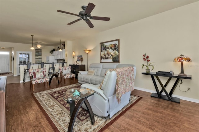 living room with wood-type flooring and ceiling fan