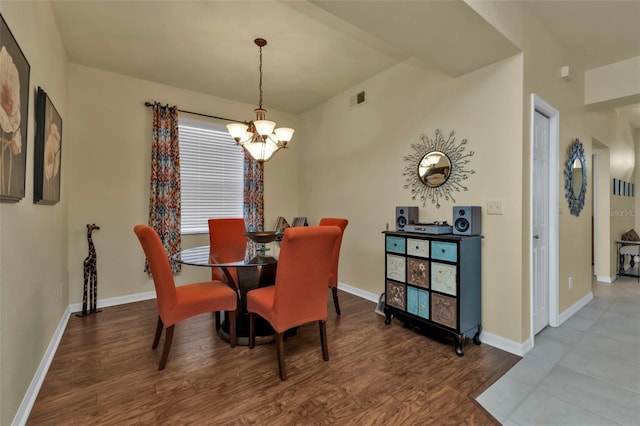 dining room featuring wood-type flooring and a notable chandelier