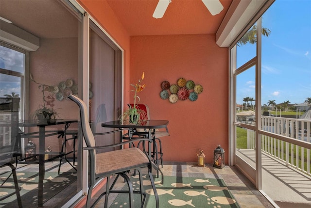 sunroom featuring ceiling fan