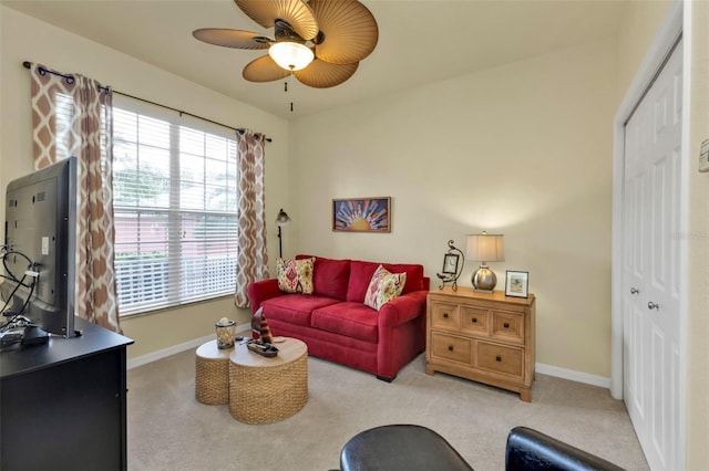 living room featuring ceiling fan and light colored carpet