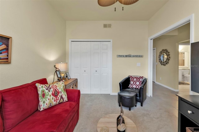 carpeted living room with ceiling fan