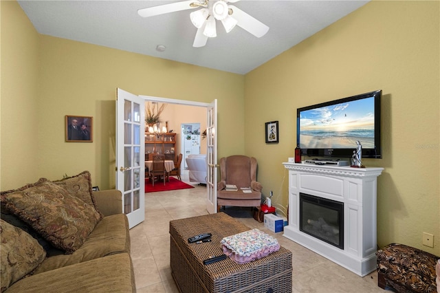 tiled living room with ceiling fan and french doors