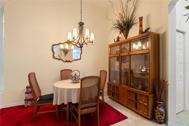 dining room featuring an inviting chandelier and light tile patterned floors