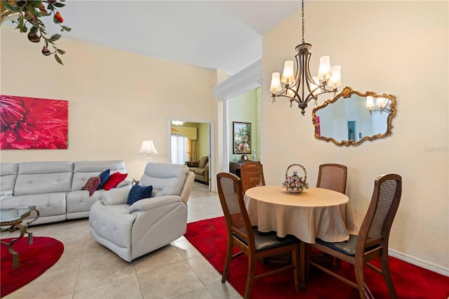 tiled dining room featuring a chandelier