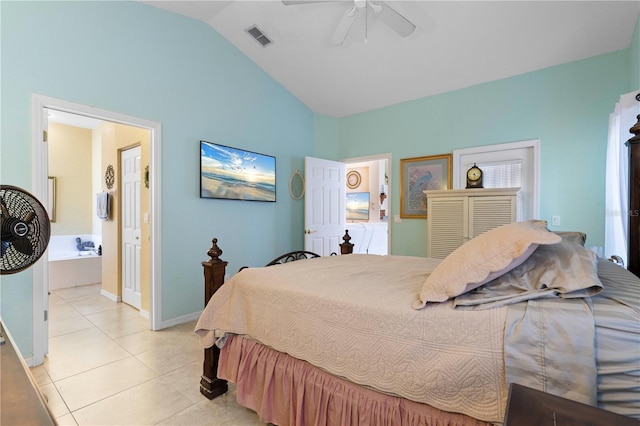 tiled bedroom with lofted ceiling, ceiling fan, and ensuite bathroom