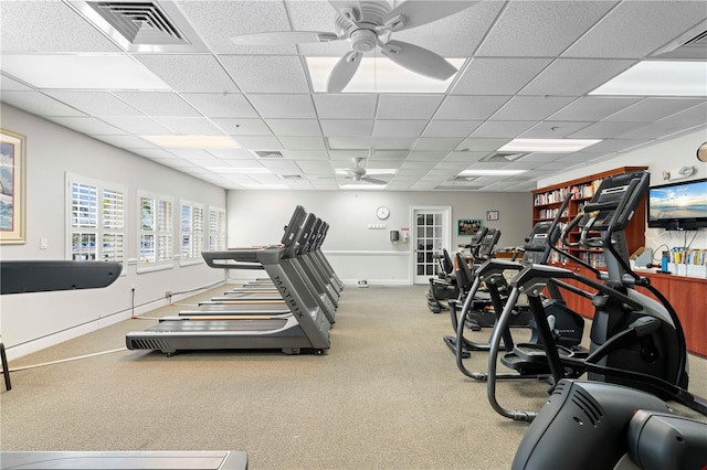 exercise room featuring ceiling fan, a drop ceiling, and carpet flooring