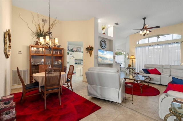 tiled dining room with ceiling fan with notable chandelier