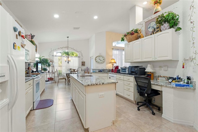 kitchen featuring white appliances, pendant lighting, an island with sink, and plenty of natural light