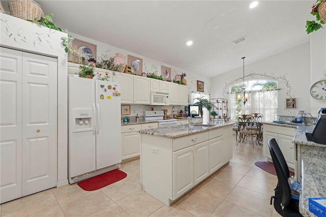 kitchen featuring white cabinets, white appliances, a kitchen island, light stone countertops, and decorative light fixtures