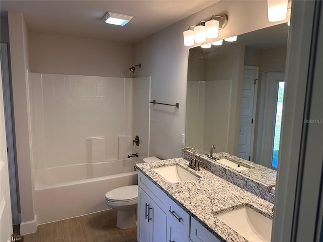 full bathroom featuring toilet, a sink, and wood finished floors