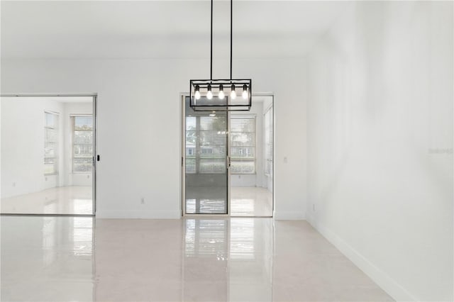 interior space with plenty of natural light and an inviting chandelier