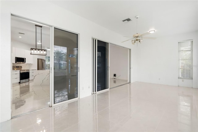 unfurnished room featuring ceiling fan and light tile patterned flooring