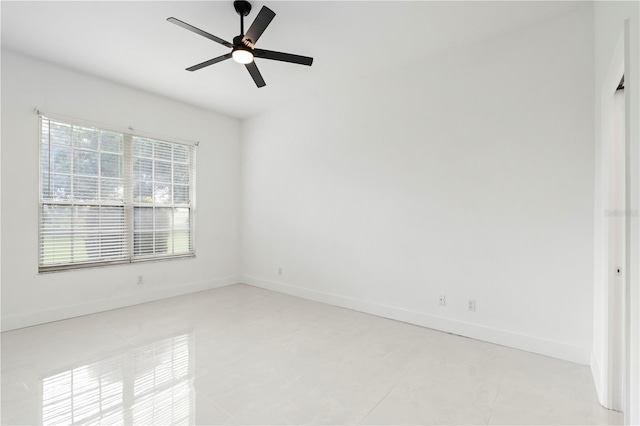 tiled spare room with ceiling fan