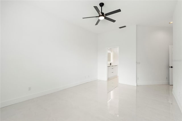 tiled empty room featuring ceiling fan