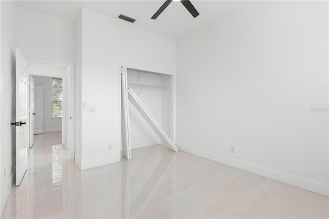 unfurnished bedroom with ceiling fan, a closet, and light tile patterned floors