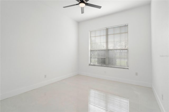 tiled spare room with ceiling fan