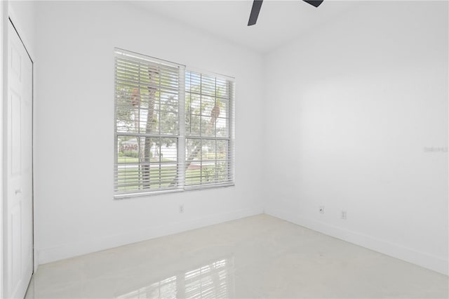 unfurnished room featuring ceiling fan and plenty of natural light