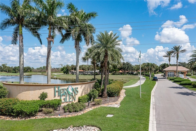 view of home's community featuring a water view and a lawn