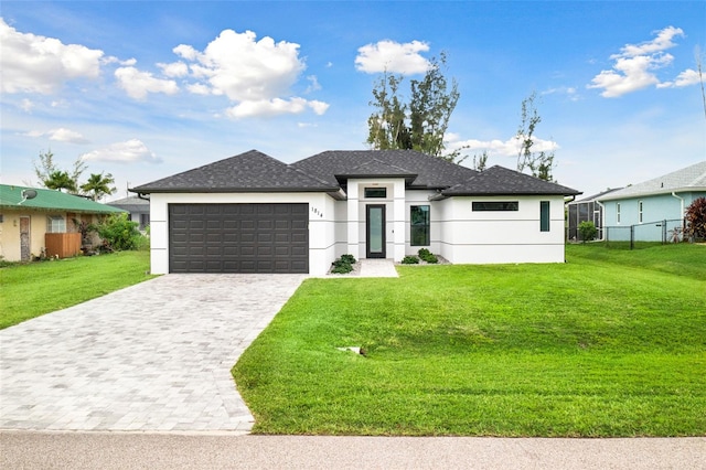 view of front facade with a front yard and a garage