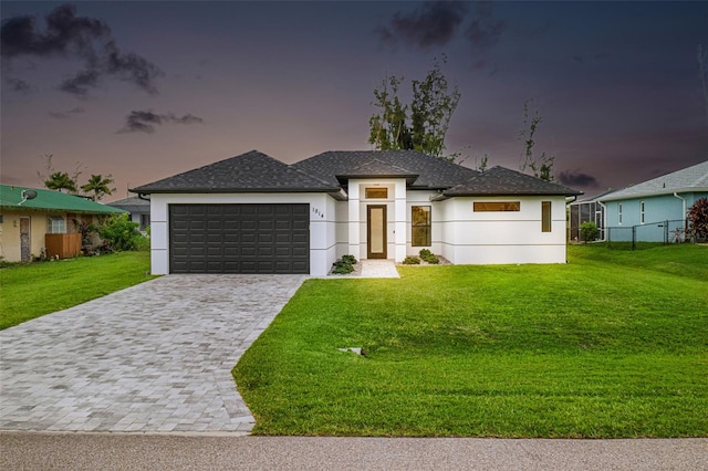 view of front of home featuring a yard and a garage