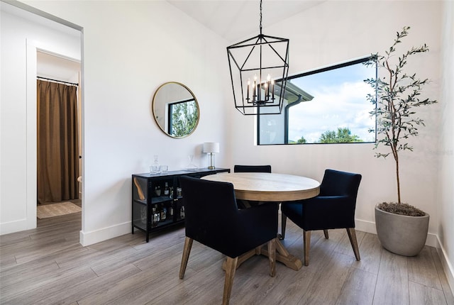 dining space featuring an inviting chandelier and hardwood / wood-style floors