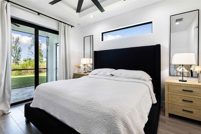 bedroom featuring ceiling fan, hardwood / wood-style flooring, and access to exterior