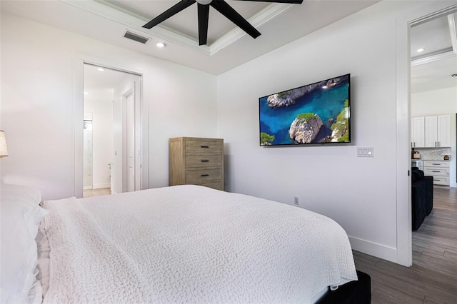 bedroom with ornamental molding, ensuite bath, ceiling fan, and dark hardwood / wood-style flooring